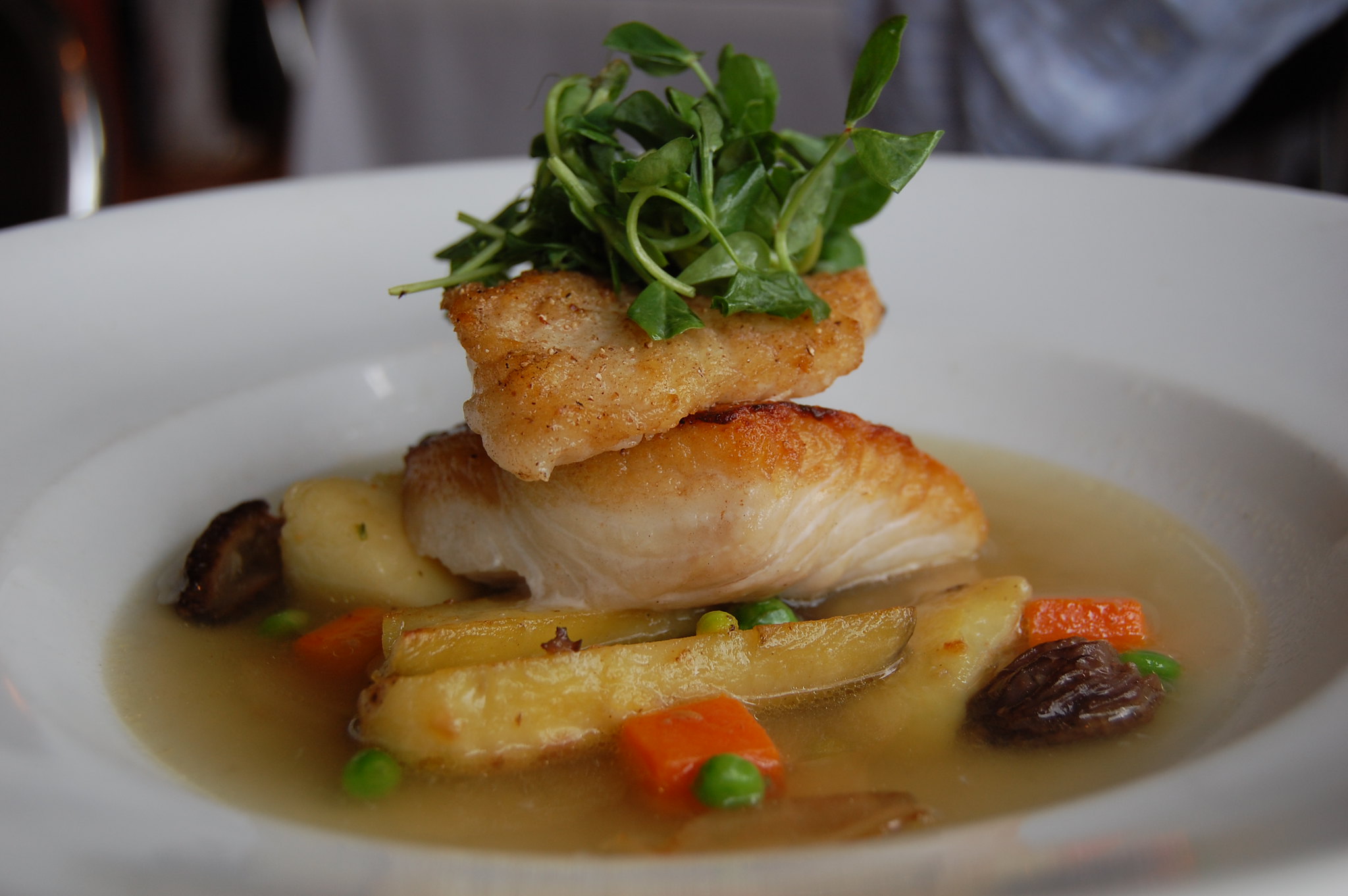 stu_spivack/Flickr halibut with potatoes, broth, and garnish