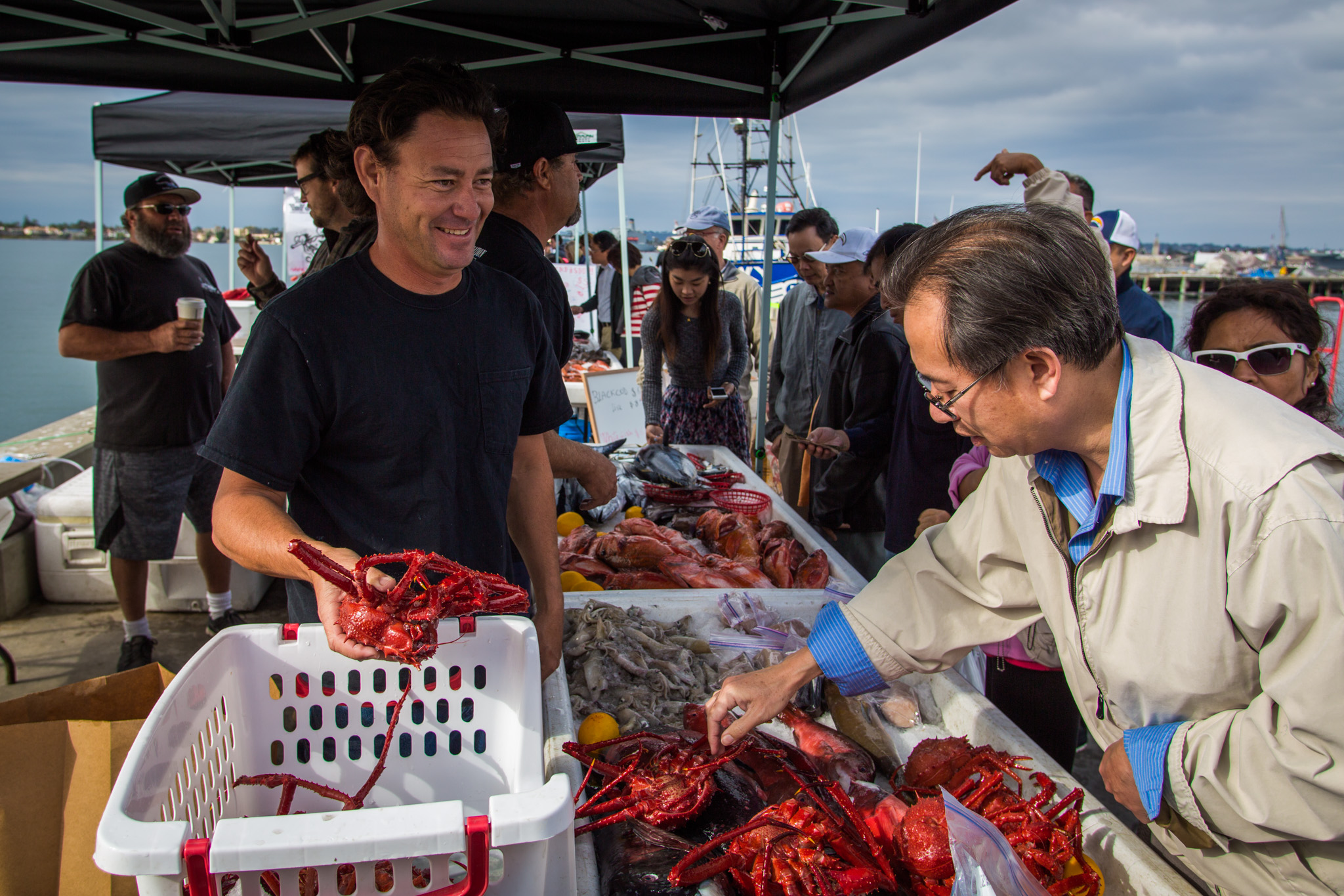 Jason Houston/California Sea Grant fisherman selling red king crab to a customer