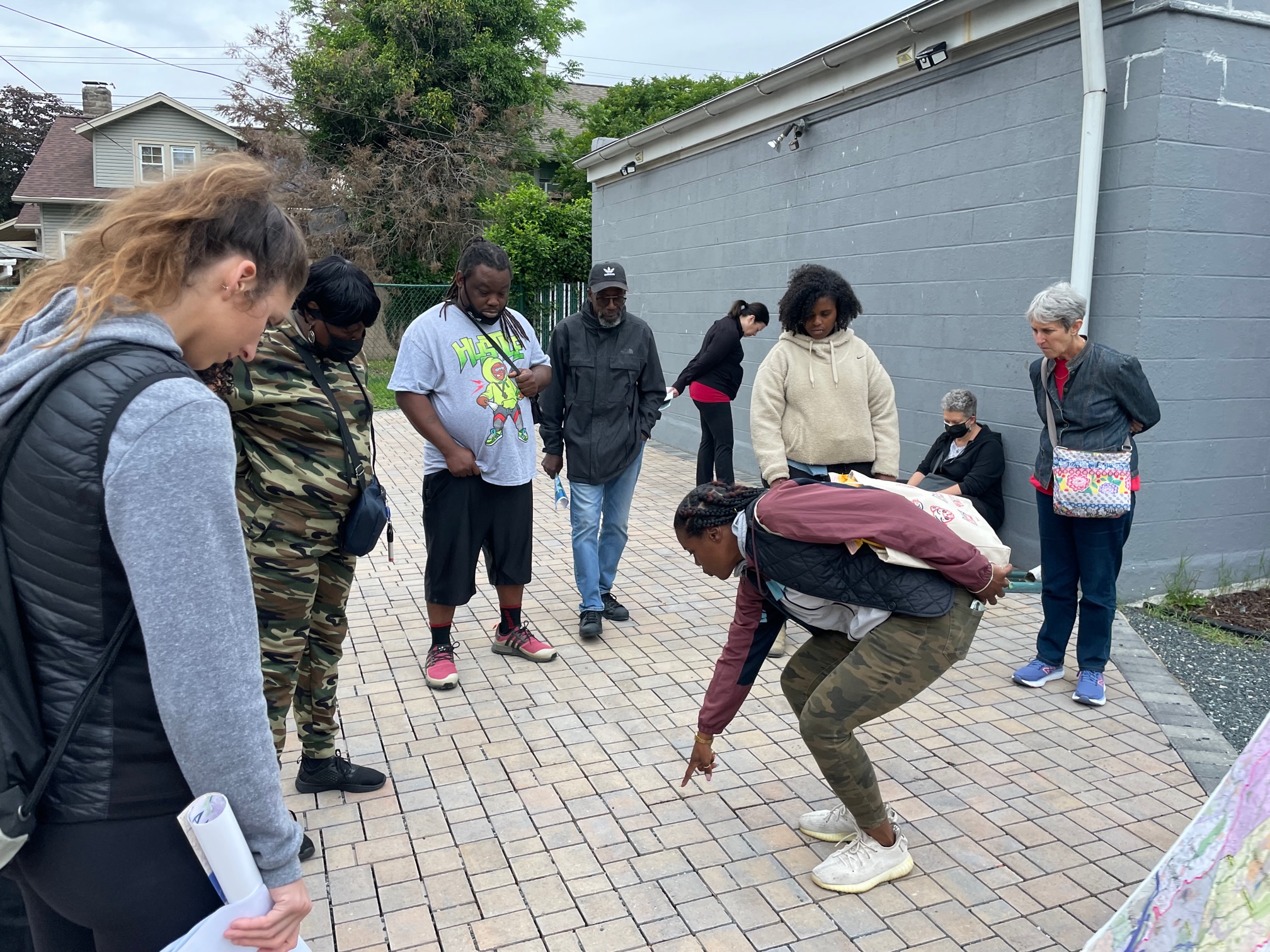 participants observing permeable pavers on walking tour