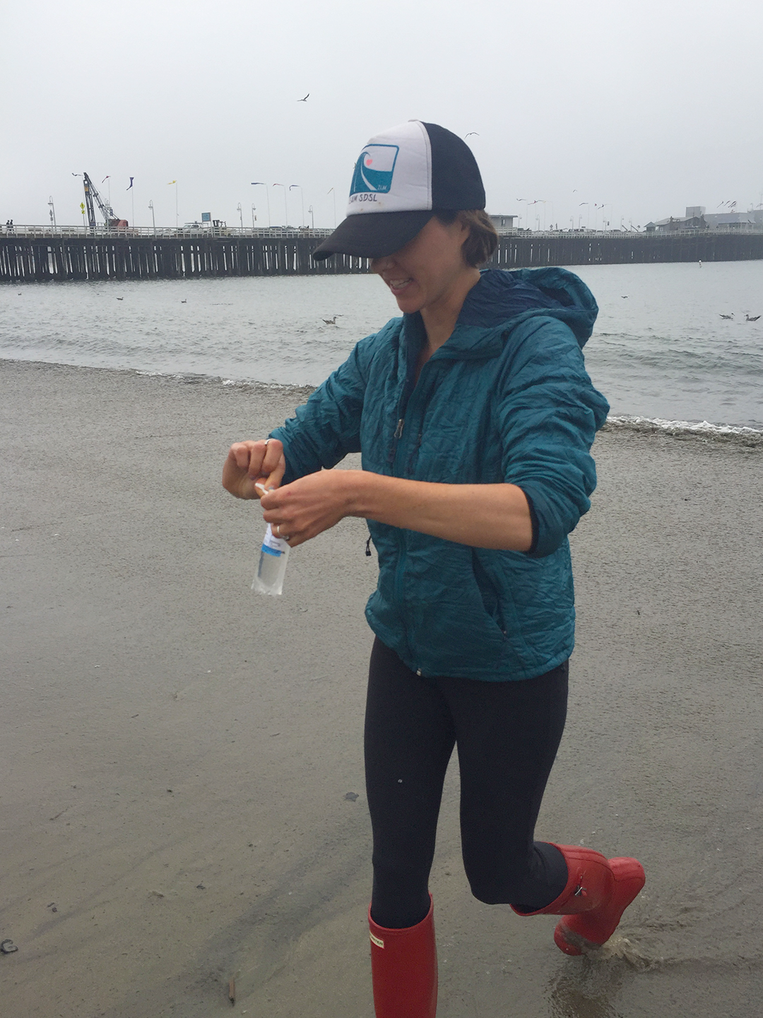 Lark Starkey collecting a water samples from one of California’s consistent “Beach Bummers” for poor water quality – Cowell’s Beach in Santa Cruz. Credit: Karen Black