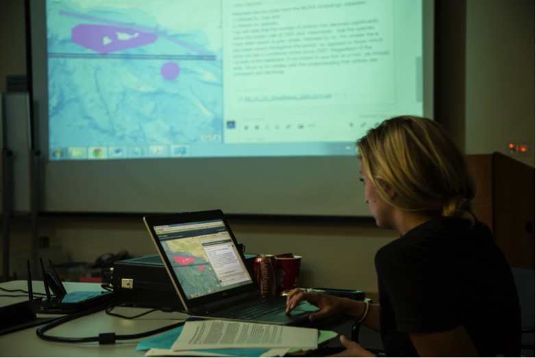 Morgan Visalli, 2015 Sea Grant Fellow at CINMS, displaying SeaSketch on the projector screen during the fourth Marine Shipping Working Group meeting in October 2015.
