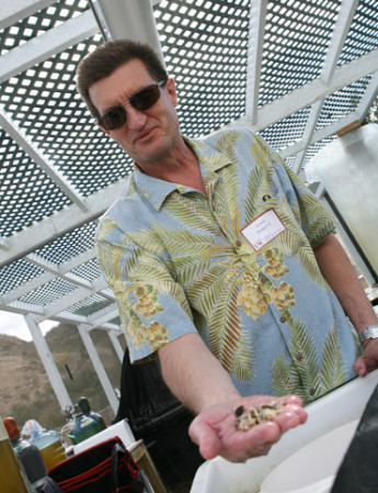 Dennis Hedgecock holds young Pacific oysters. Credit: USC
