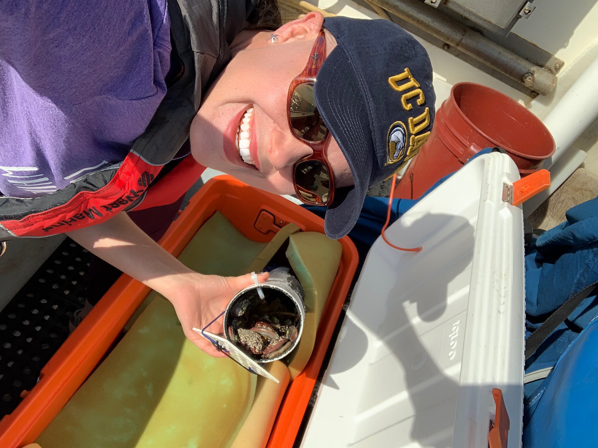 scientist on a boat with white abalone