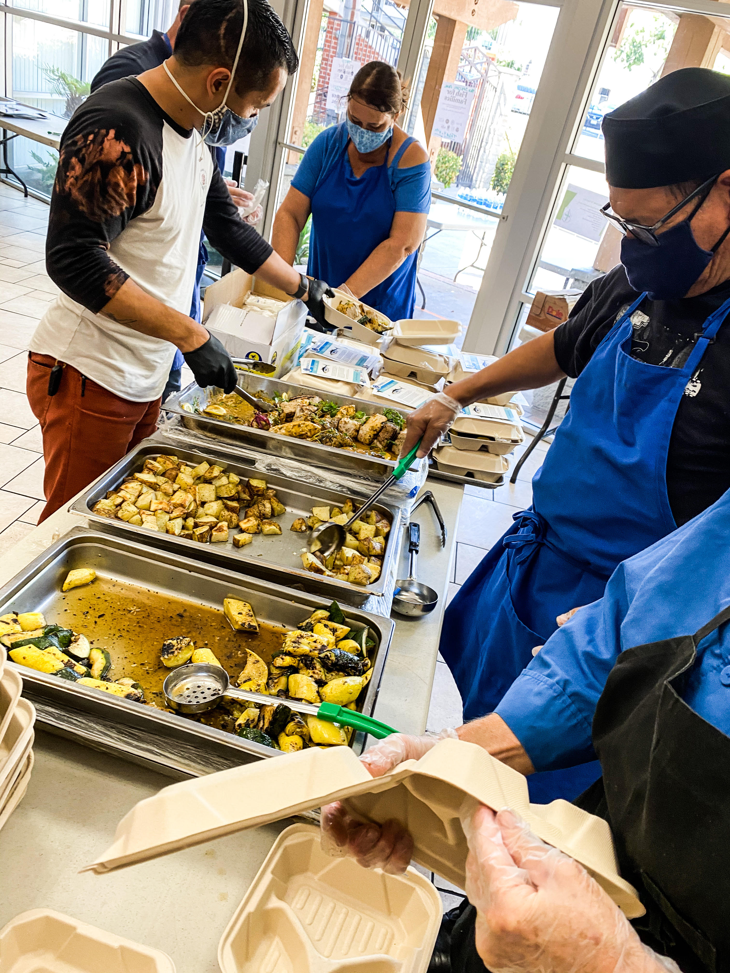 Chef Marcus Twilegar helps to serve his healthy, sustainable seafood meals at the Third Ave Charitable Organization. Photo: Jam Zumel