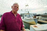 Commercial fisherman Pete Halmay in front of his boat.