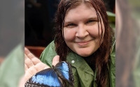 Photo of Bryndan Bedel with blue morpho butterfly in Costa Rica