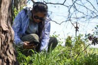 Kristine Cabbage kneeling in grass for monitoring