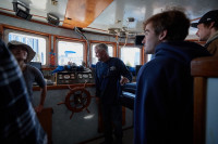 Young fisherman in the cockpit of a vessel