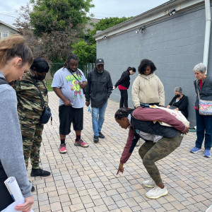 participants observing permeable pavers on walking tour