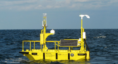 Picture of yellow metocean buoy in the ocean