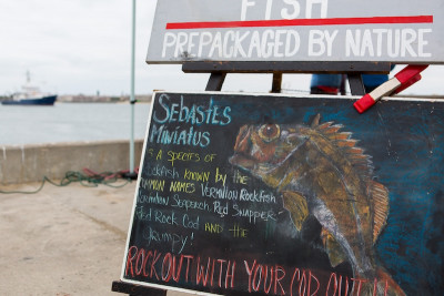 A hand-written sign advertising rock fish