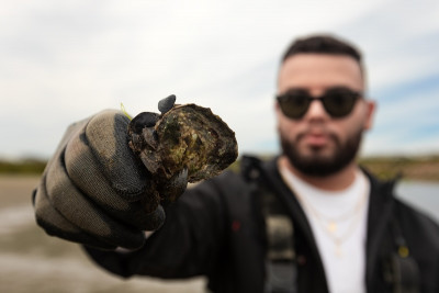 Brandon holding an oyster