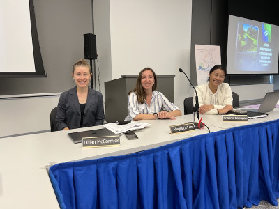 Lillian McCormick and two other young women sitting on a panel