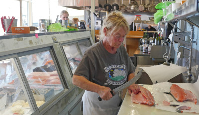 Amber Morris, the fish buyer for Local Ocean's restaurant and fish market in Newport, fillets a Chinook salmon