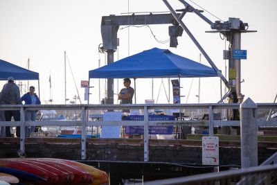 vendor booth in front of hoist at fishermen's market 