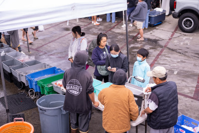 customers at a booth at the ventura county fishermen's market