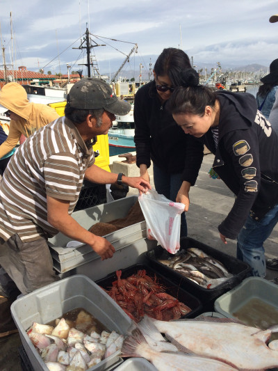 vendor selling seafood to customers
