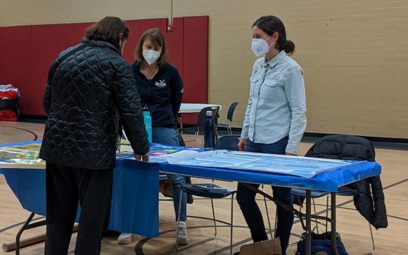 Jess Rudnick (center), an extension specialist with California Sea Grant, speaks with residents at a community event in South Stockton in 2022