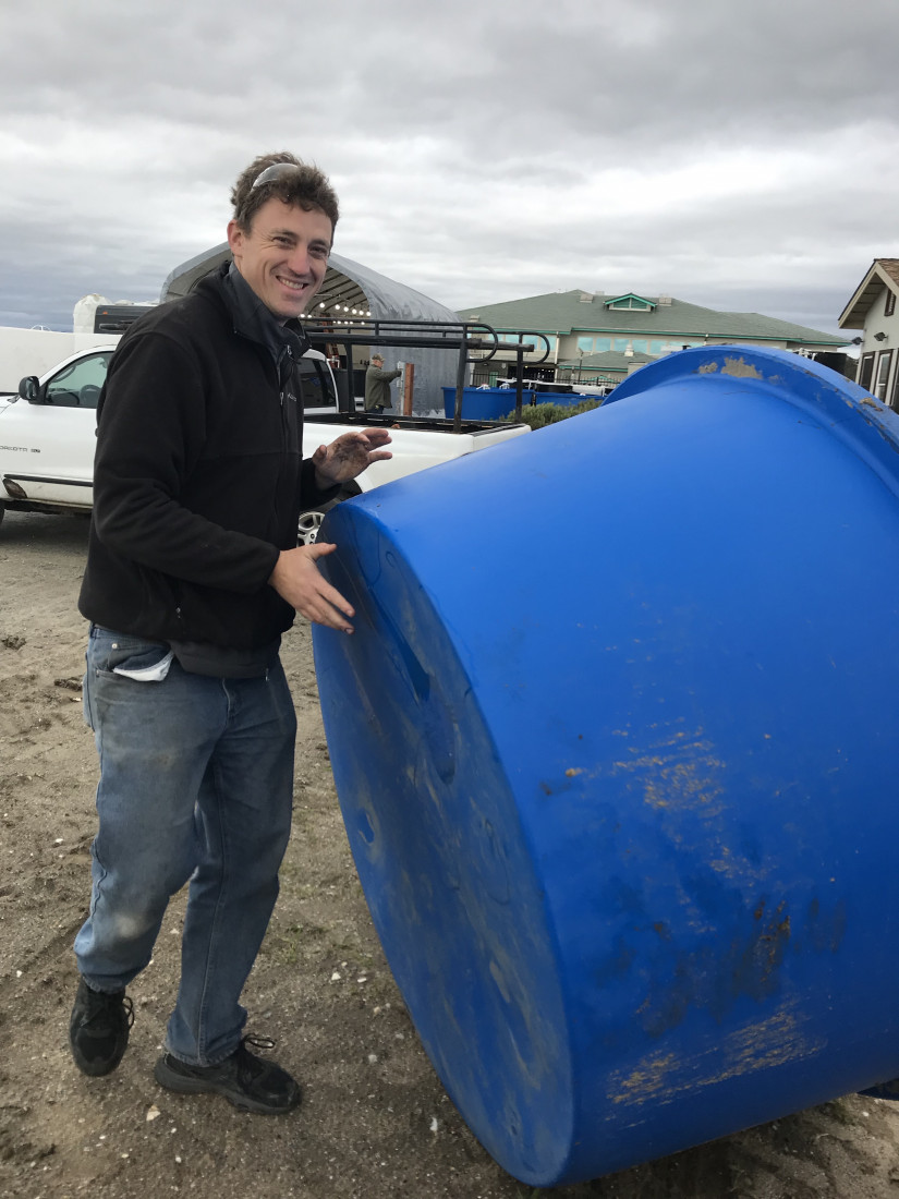 California Sea Grant Extension Specialist Luke Gardner moving the large tanks that will eventually hold the experimental urchins.