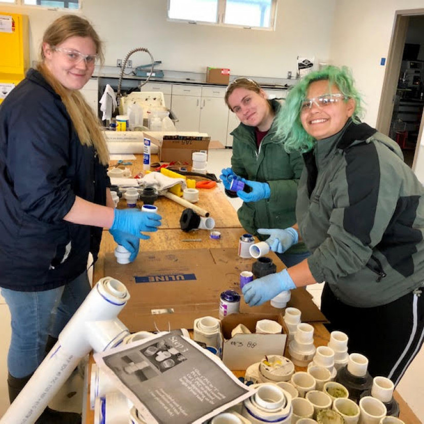 Katrina Herrmann, Kayla Roy, Helaina Lindsey, and Walan Chang hard at work creating the plumbing for the experimental setup.