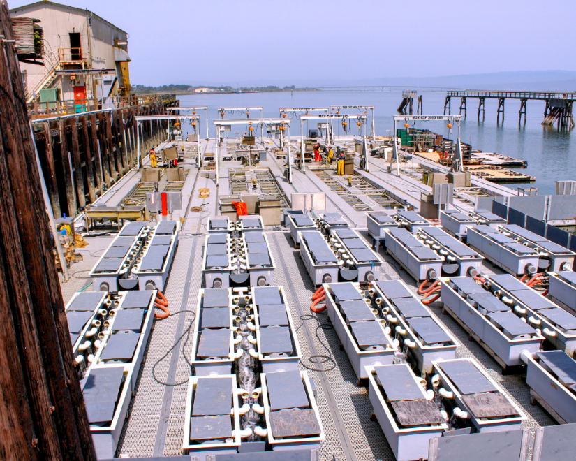 This is a floating upwelling system or FLUPSY in Humboldt Bay. Mariculture businesses use these devices to grow out oysterseed. The devices pull water and nutrients through container that hold oyster seed, allowing the seed to grow to a larger size. Courtesy of Robert Dumoucel.