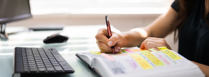 person adding things to planner