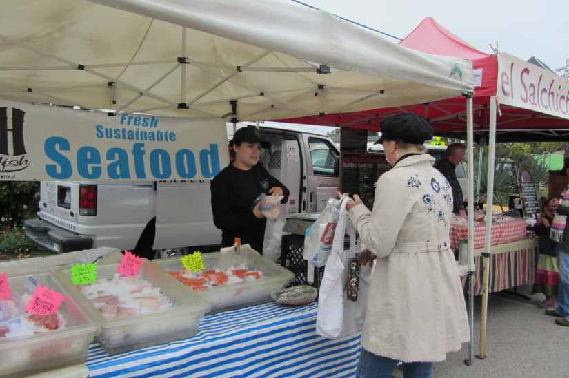woman buying fish at a market