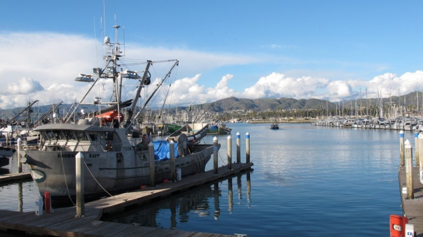 Fisher boat docked in harbor front lateral view