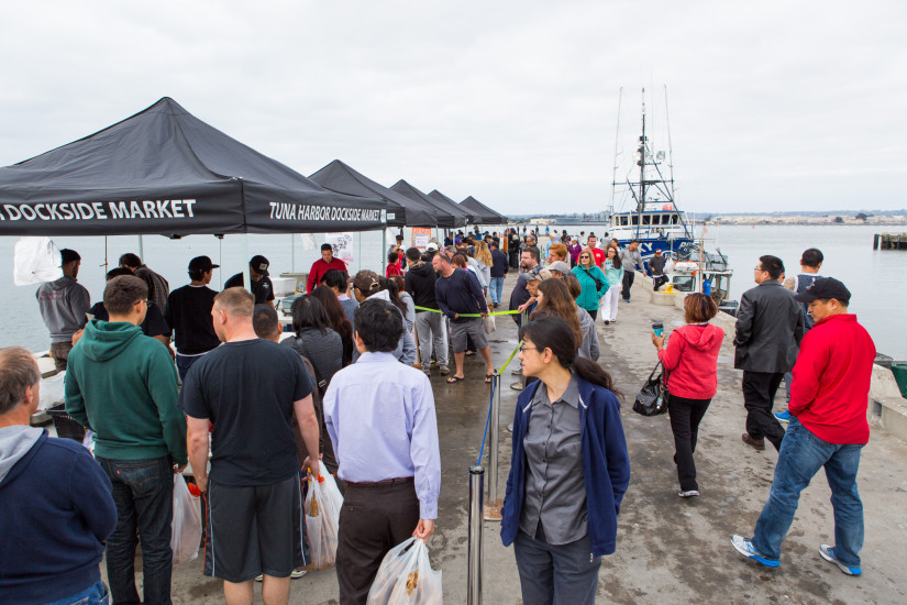 crowd walking around tuna harbor dockside market