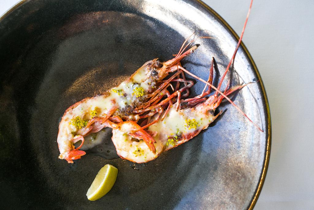 cooked spot prawn with lemon wedge