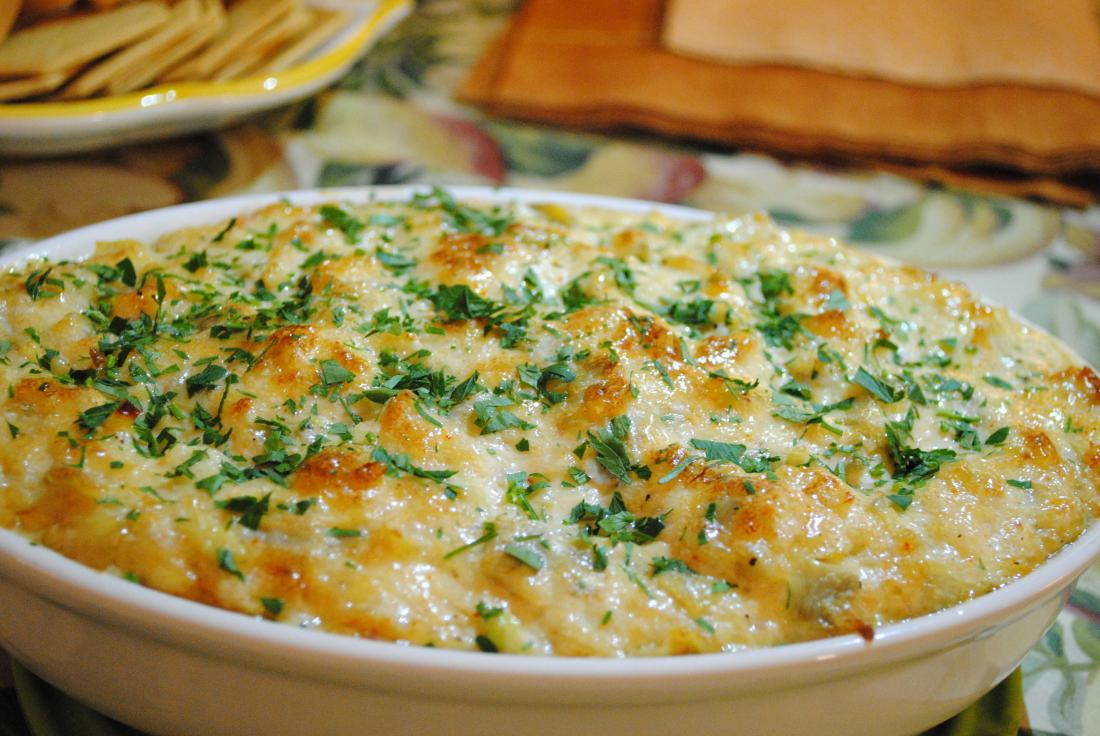 Crab dip garnished with parsley.
