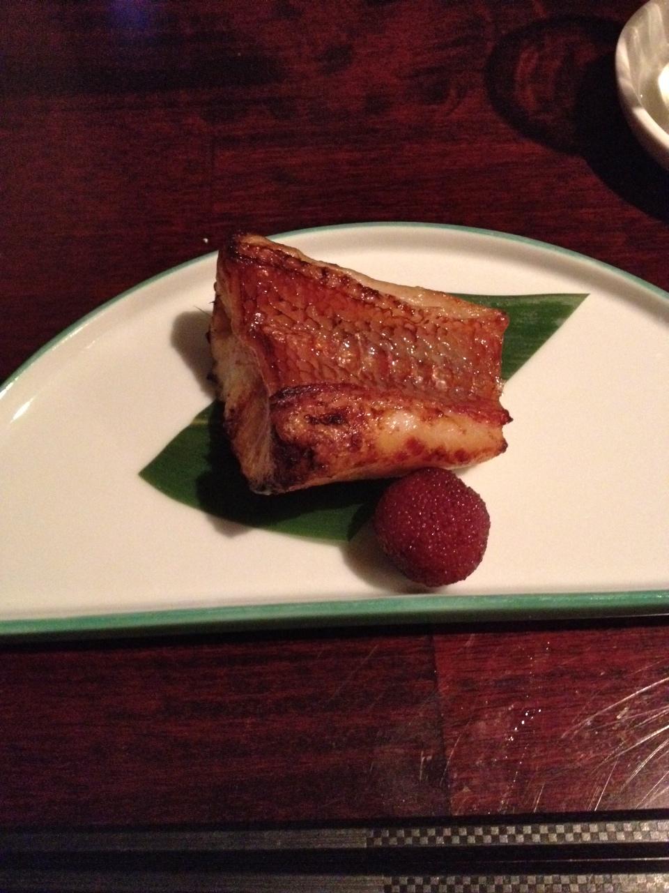 grilled thornyhead filet served on a semicircular plate 