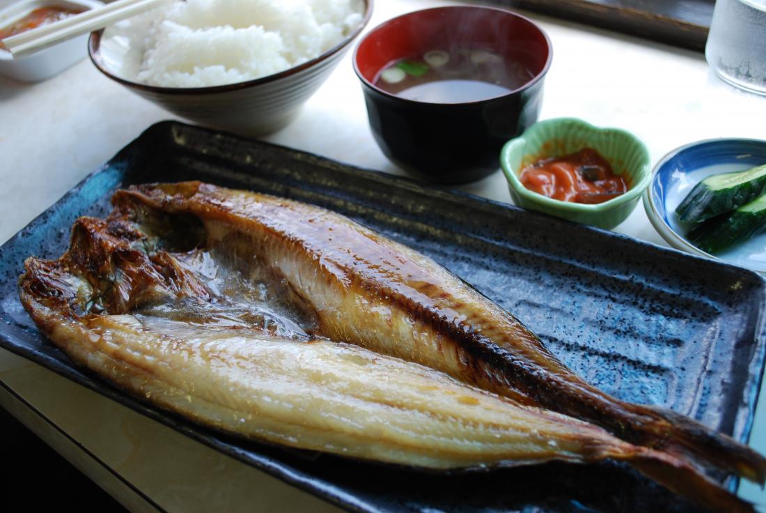 Grilled mackerel with rice, miso soup, and vegetable side dishes.