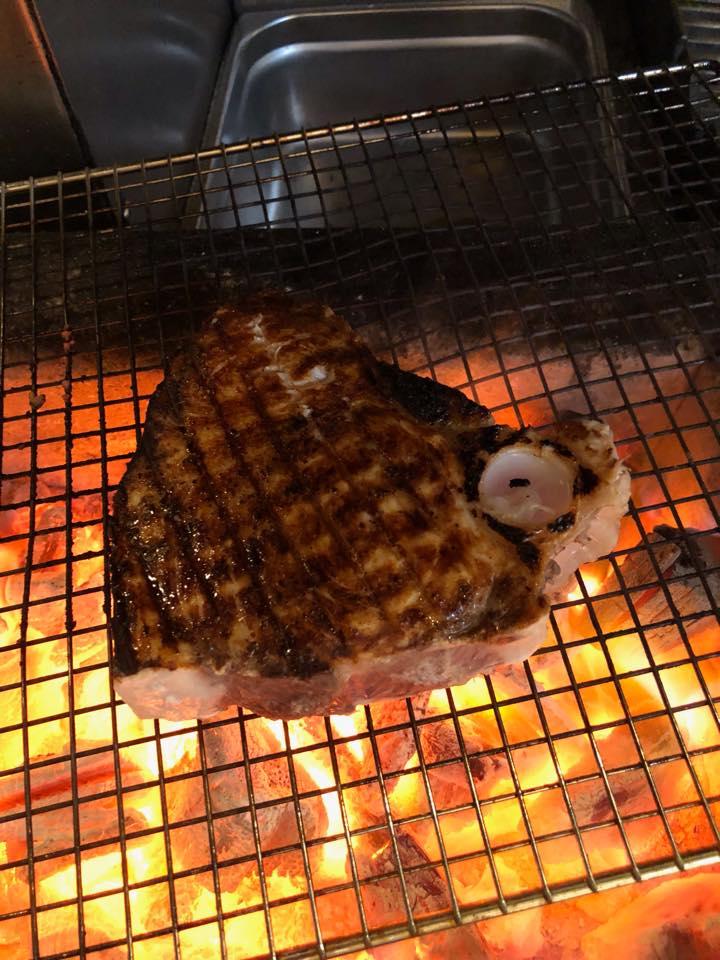 Swordfish grilling over a wood fire.