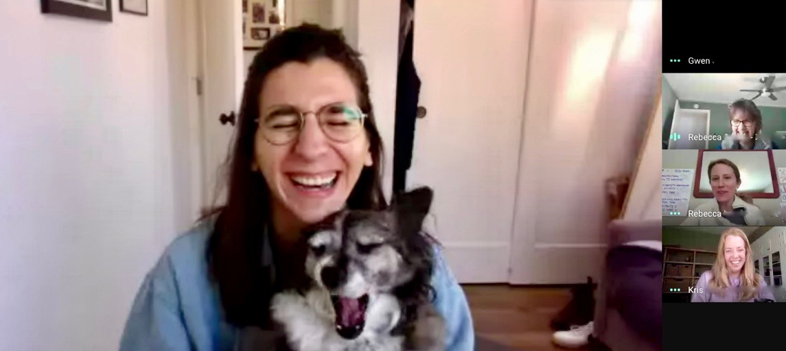 Zoom screenshot of woman holding a dog and laughing